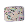 A small rectangular card holder or wallet with rounded corners, featuring a pastel multicolor watercolor-style print with cartoon unicorn illustrations and text including 'LET THAT' and 'STFU'.