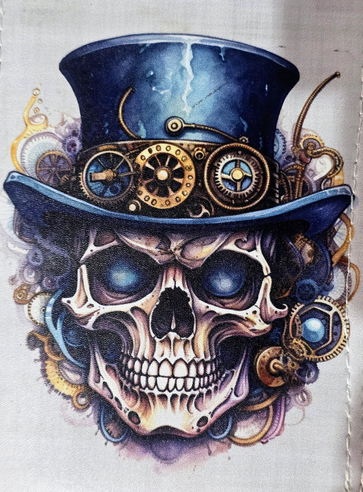 Close-up of steampunk skull artwork featuring a blue mechanical top hat, brass-colored gears, and intricate Victorian gothic details.