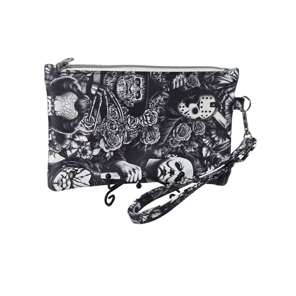 A black and white gothic-themed clutch purse with a wrist strap, featuring a detailed print of skulls, roses, a knife, and a hockey mask on a plain white background.