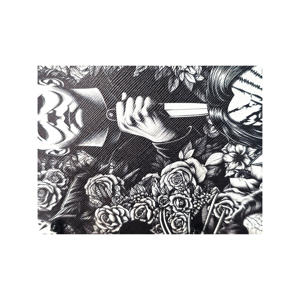 Black and white graphic print featuring a hand holding a knife surrounded by roses and illustrated faces, shown on a rectangular product against a white background.