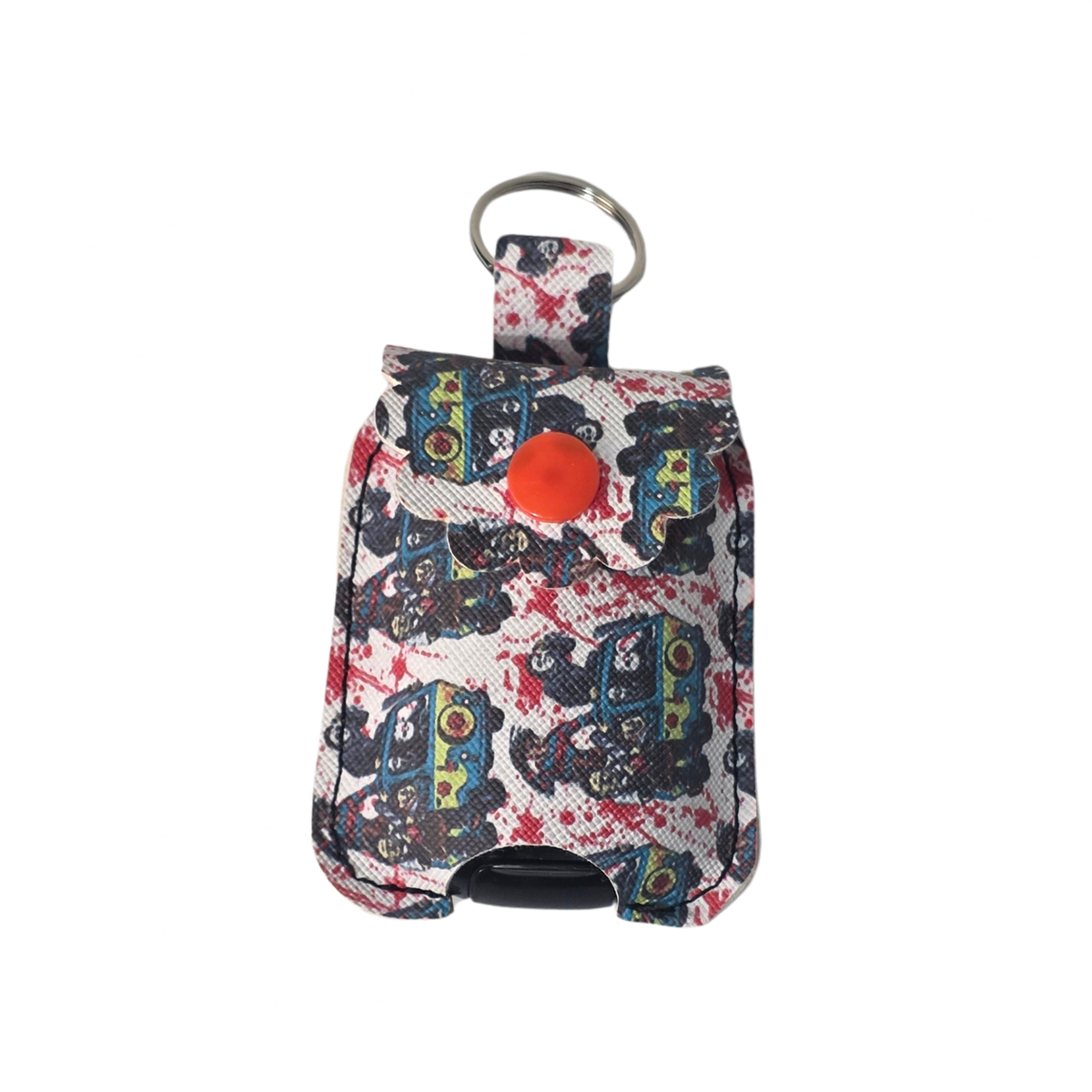 A small fabric pouch or key holder with a colorful abstract print, featuring a silver metal key ring at the top and a bright orange circular detail on the front, set against a plain white background.