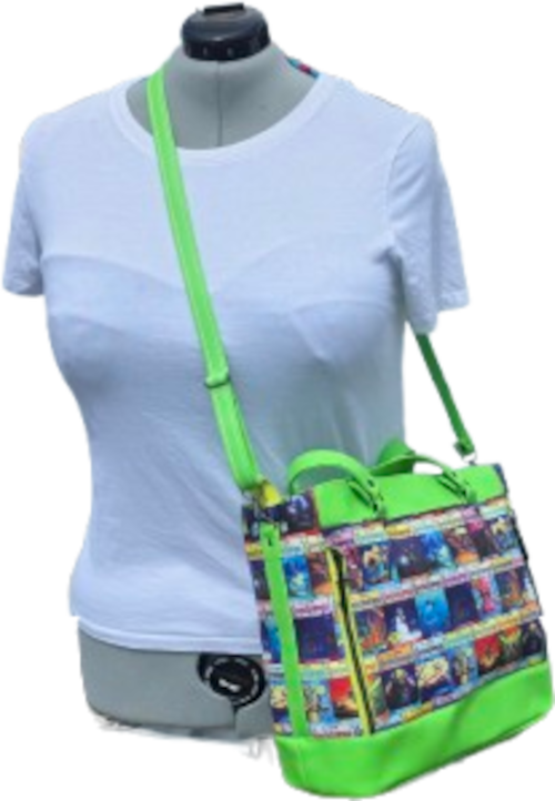 A bright green crossbody bag with a colorful comic book print pattern, displayed on a gray female mannequin torso wearing a white t-shirt.