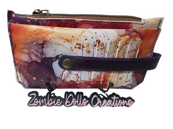 ZombieDolls Creations Autumn Ghost Purse Pal wallet with abstract fall-toned ink pattern and purple leather strap.